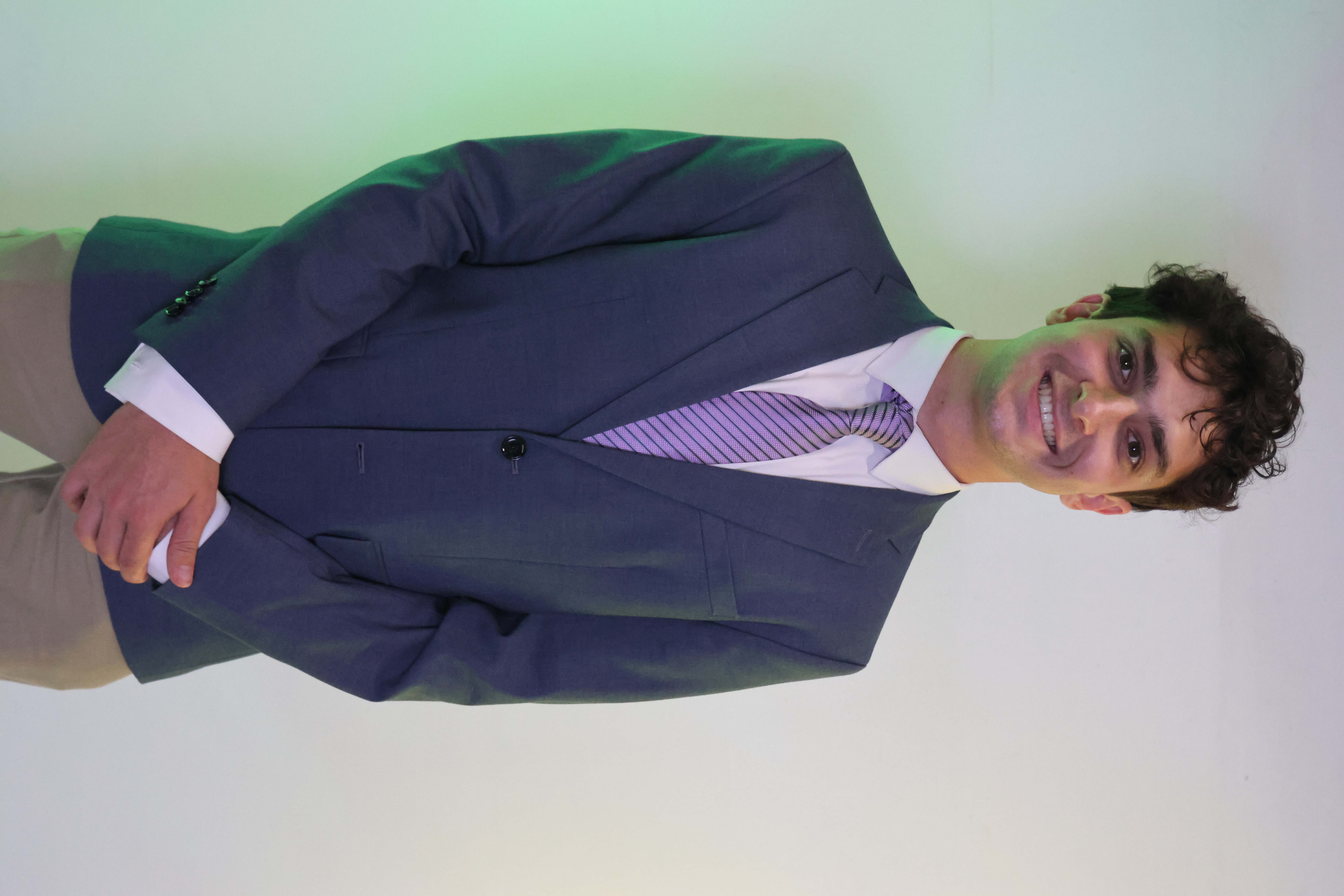 Elliot Watts-Zagha in a blazer and tie